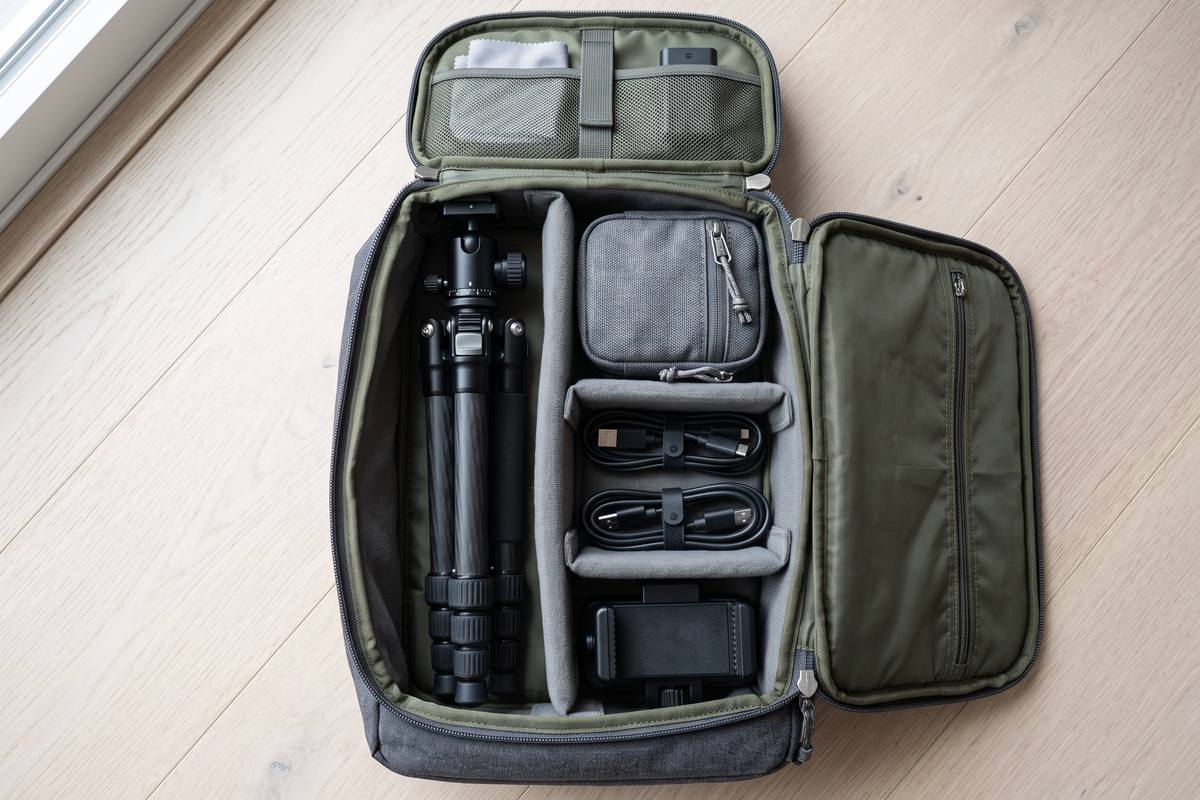 Compact tripod with a smartphone clamp on a light surface